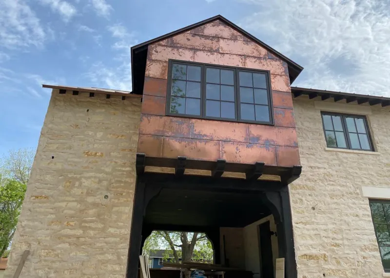Copper metal panel facade on a stone building for Skylight Installation in Lexington